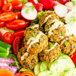 quinoa and vegetable meatballs surrounded by assorted vegetables